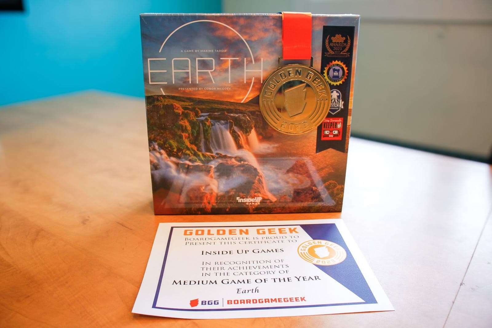 The Golden Geek 2023 medal hanging on the Earth box